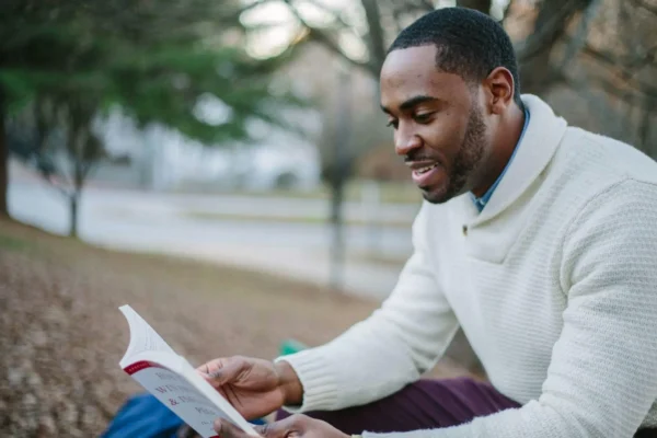 An adult learner reading confidently after learning phonics.