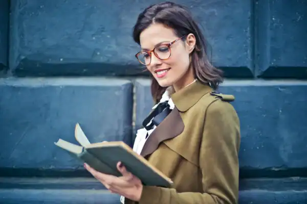 Adult woman practicing fluent reading aloud. 