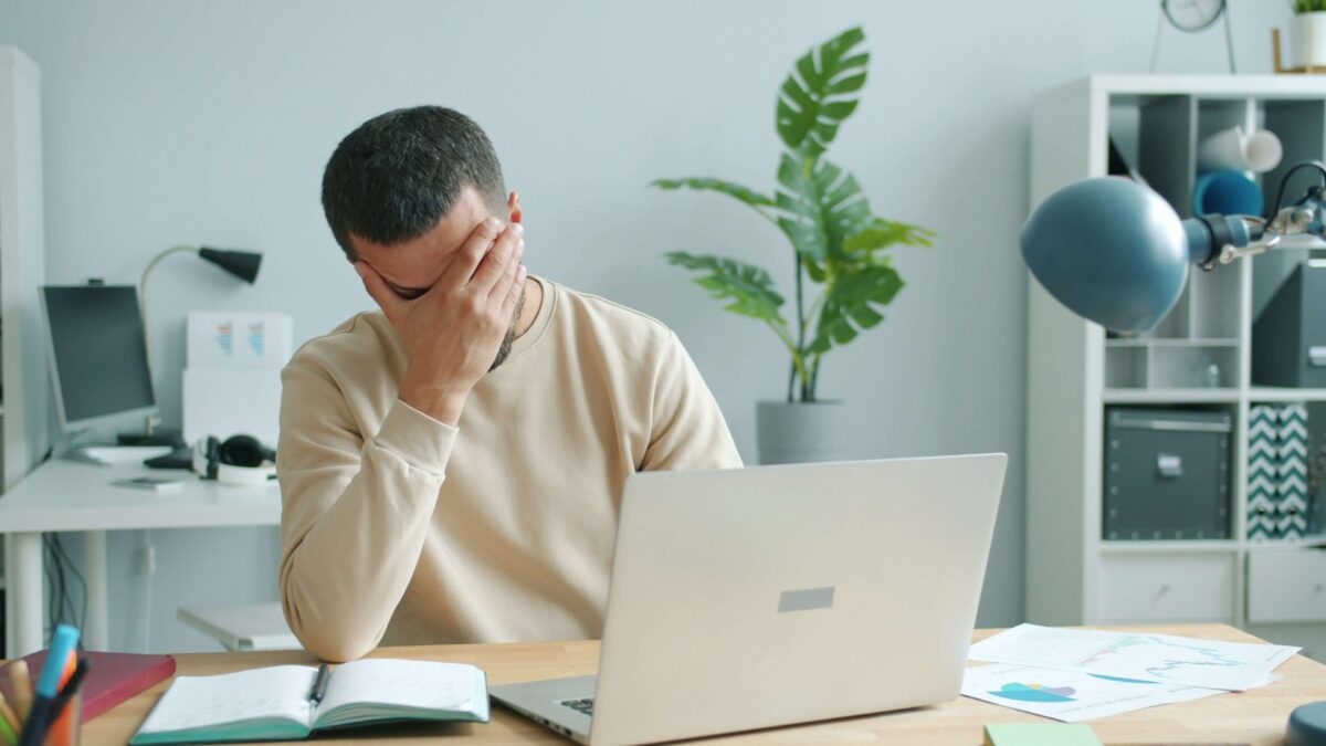 teenager struggling with reading while studying at a desk