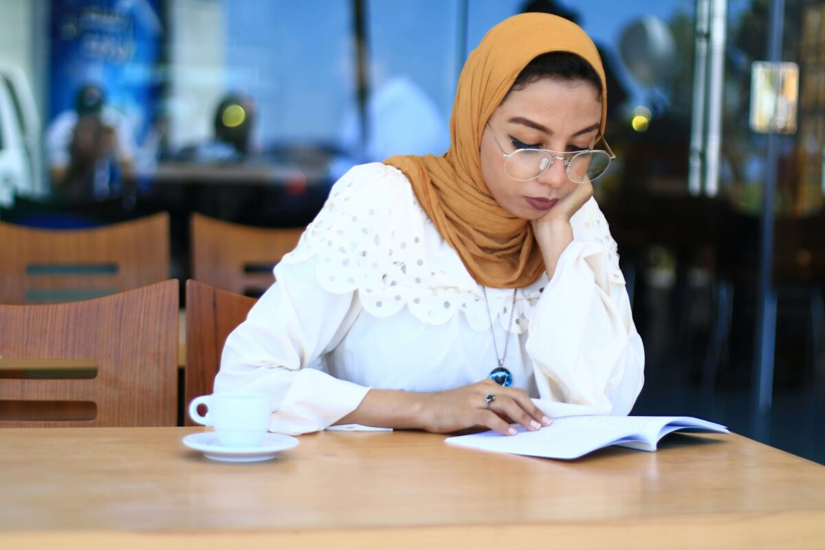 adult practicing reading with phonics materials at a desk