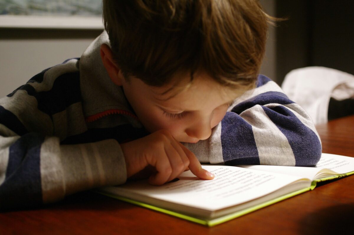 teenager practicing reading at a desk to improve reading skills